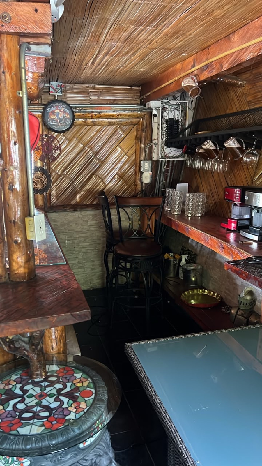 The bar — live-edge wood and stained glass